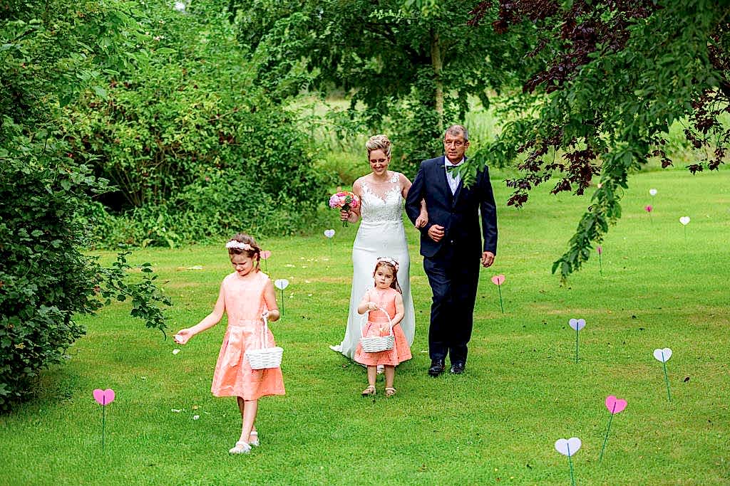 Bride walking down the aisle with her father at Belgium Garden Wedding