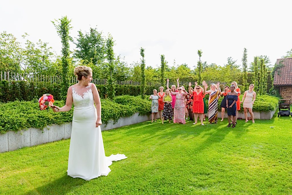 Bride throwing the bouquet at Belgium Garden Wedding