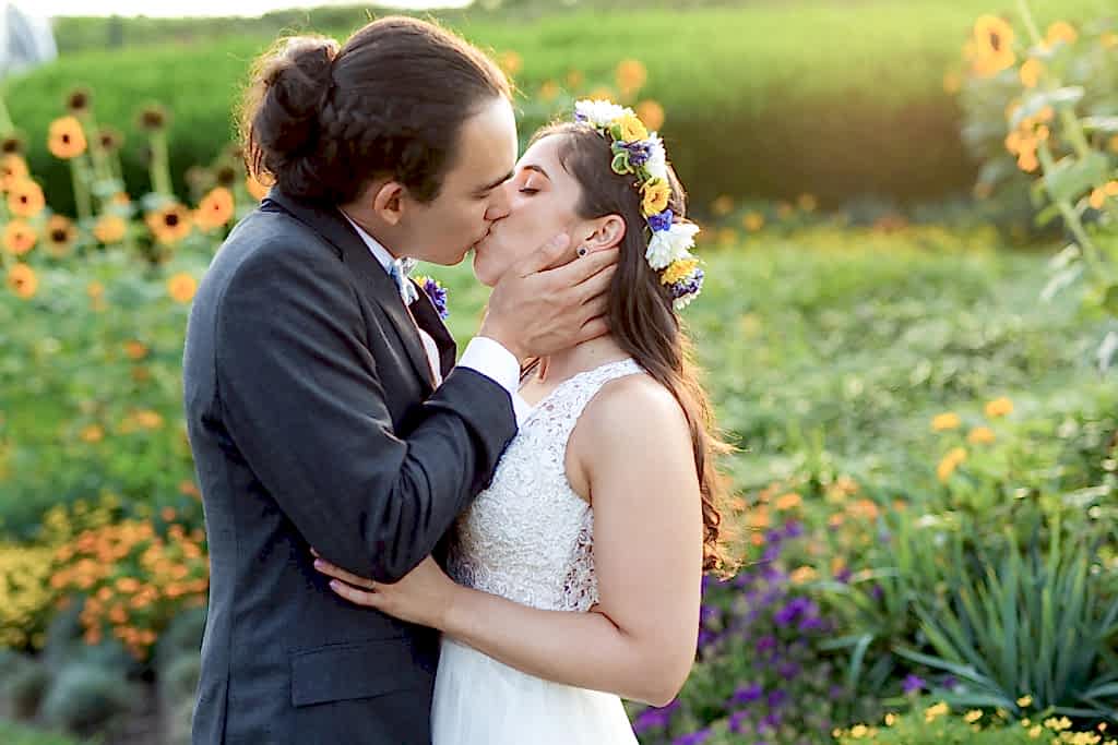 Phipps Conservatory Wedding bride and groom kissing among sunflowers