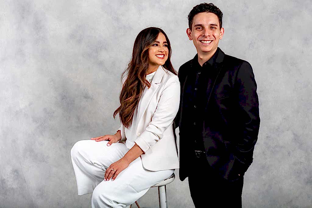 girl dressed in white looking at fiance during engagement session