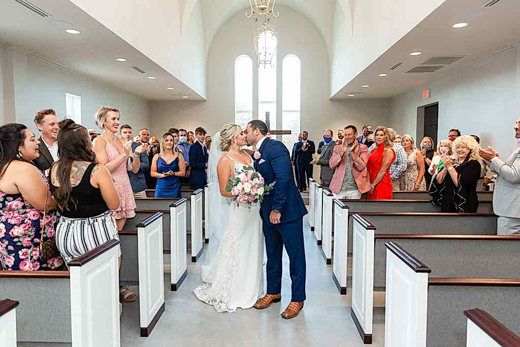 Couple kissing after wedding ceremony
