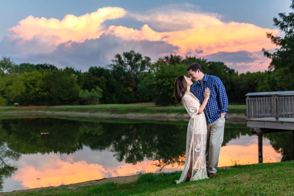 engagment session on a lake with bride and groom embracing with man leaning into the woman romantically including Tips to Help You Plan Your Engagement Session