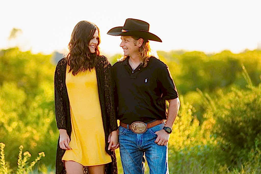 Texan engaged couple smiling at each other in a park during Tandy Hills engagement session
