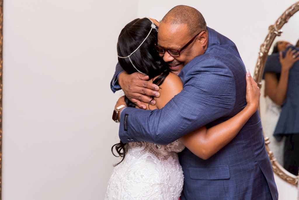 Father hugging bride