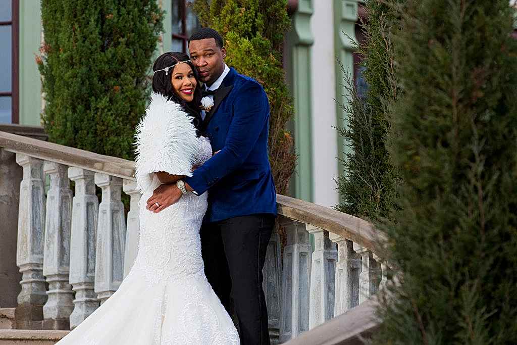 Bride and groom posing on stairs