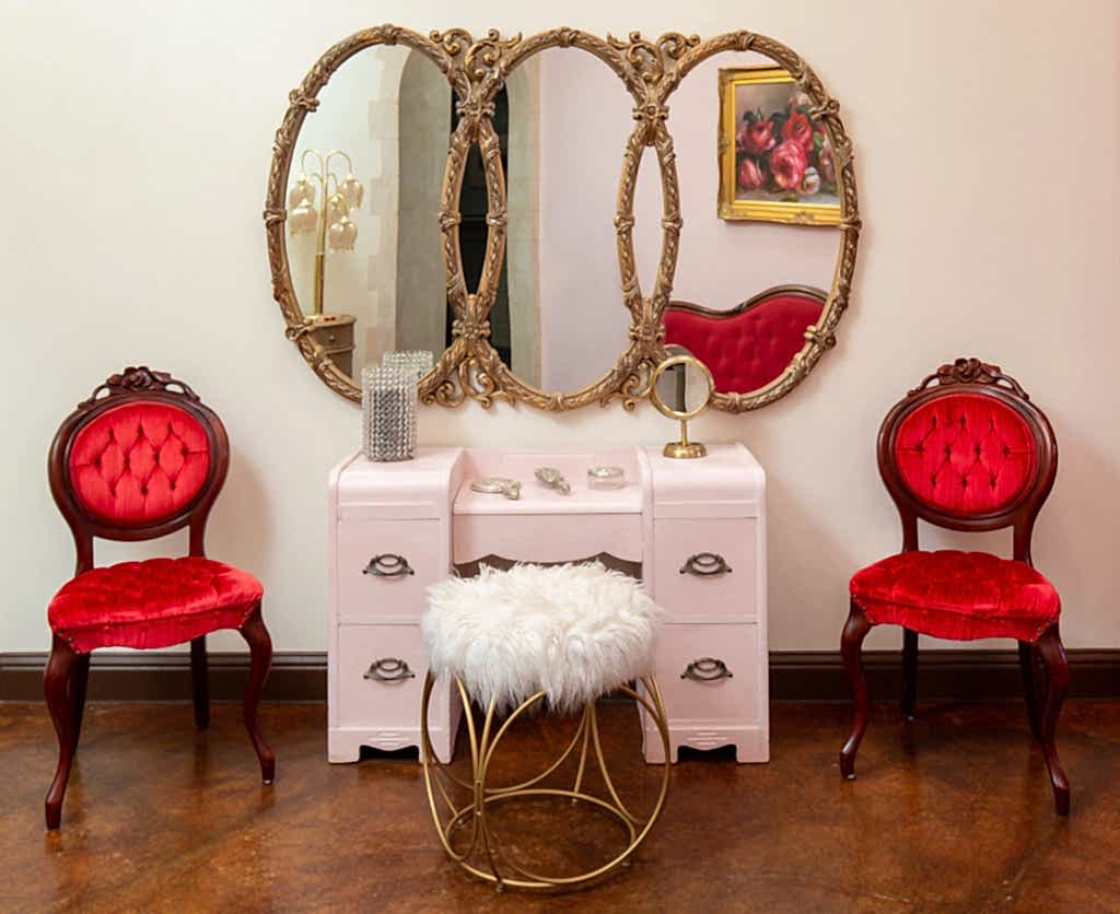 bridal getting ready area with a small vanity and read chairs