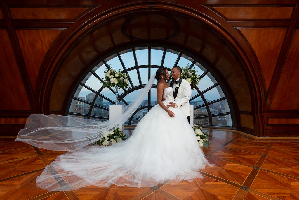 Bride and groom with flying veil in upper ballroom at Hotel Crescent Court in downtown Dallas