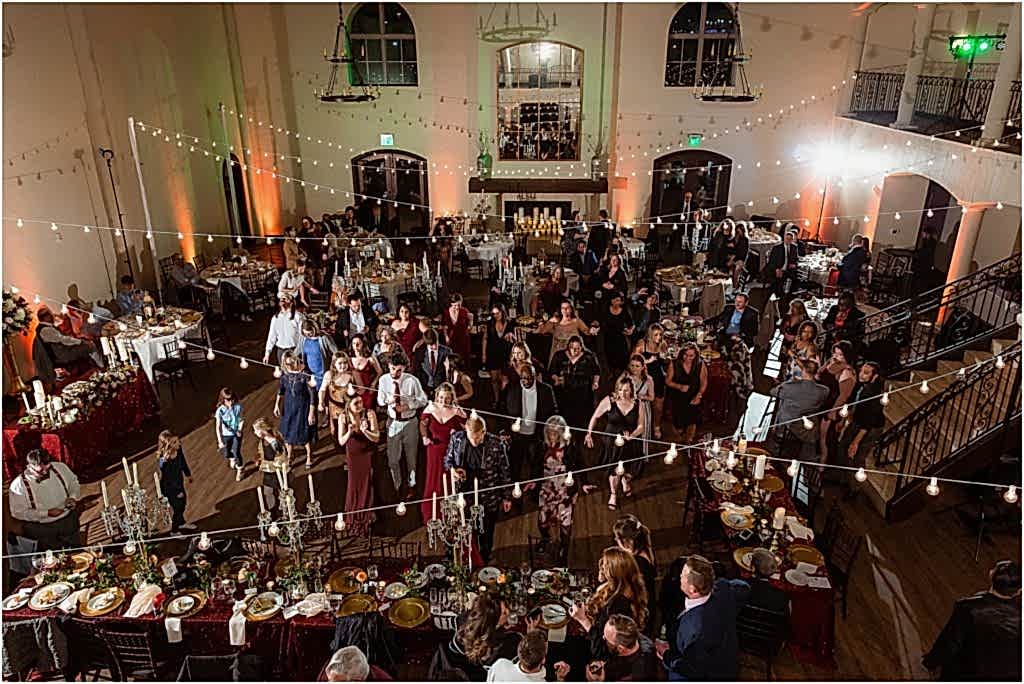 A side view of guests dancing during reception at a luxury wedding venue photographed by Dallas wedding photographers