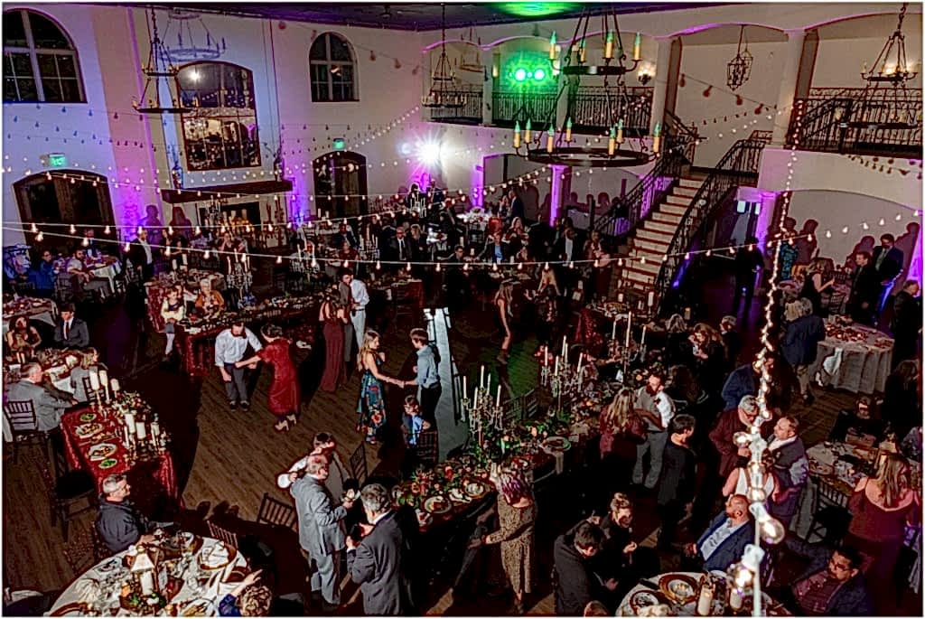 Dallas wedding photographers photograph an overview of the full reception with twinkle lights and dancing at luxury wedding venue