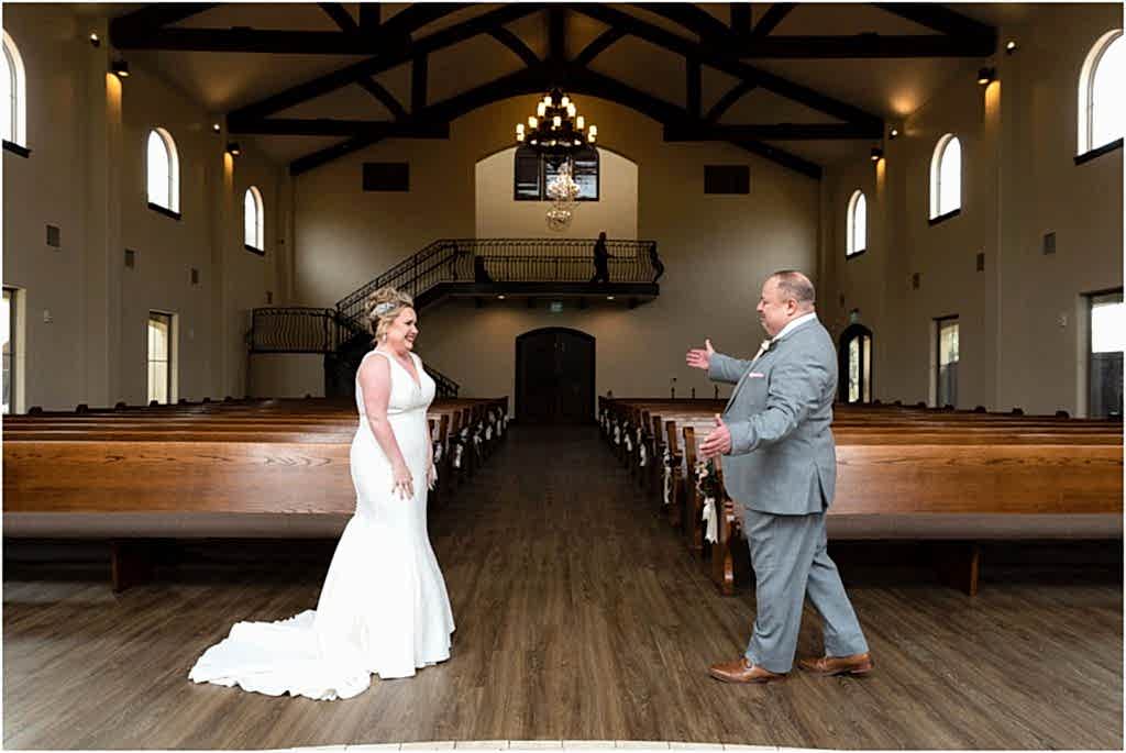 first look before the wedding cermeony with man holding out his arms to his groom and bringing her in for a hug photographed by Dallas wedding photographer