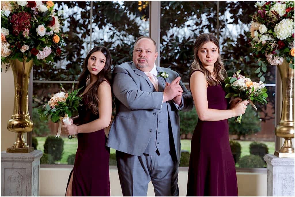 Groom and two daughters pose like Charlie's Angels for portrait taken by Dallas wedding photographers