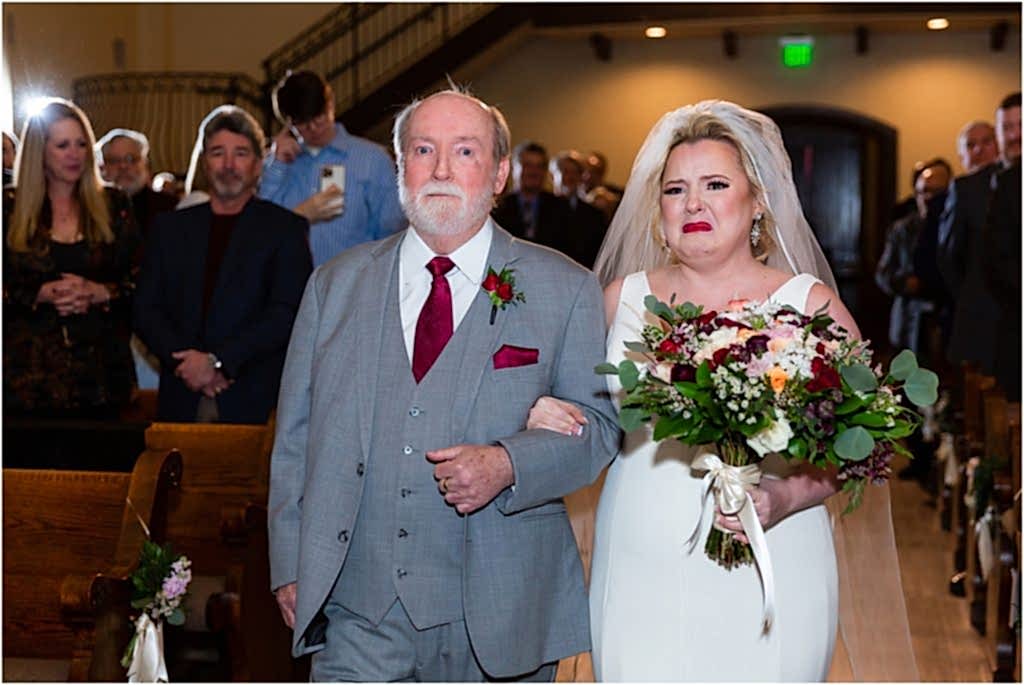 bride crying as she walks down the aisle at chapel ana villa texas photographed by Dallas wedding photographers