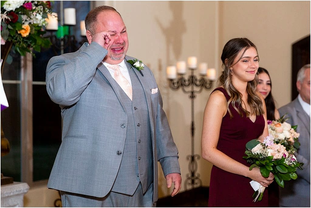 groom crying as bride walks down the aisle in dallas texas photographed by Dallas wedding photographers