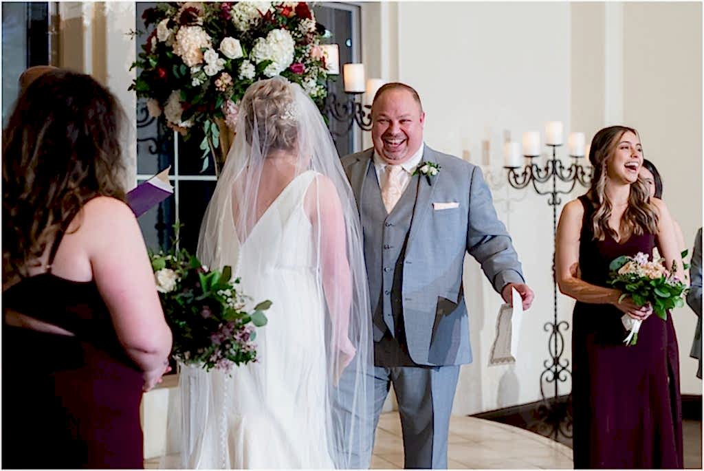 Groom jokes and bridesmaids laugh during vows at Ana Villa wedding ceremony photographed by Dallas wedding photographers