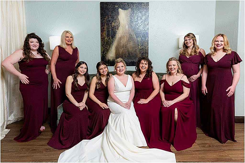 capture the bride and bridesmaids sitting on couch in bridal suite at chapel at ana villa wedding venue