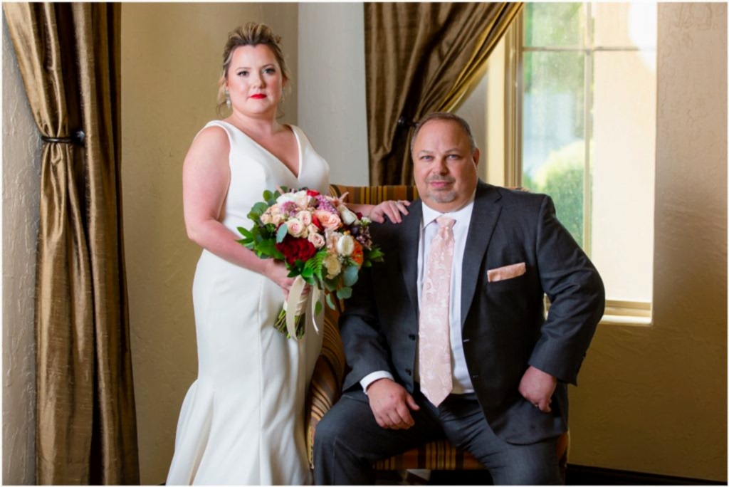 Serious photo of bride and groom in front of windows and gold curtains at Ana Villa wedding photographed by Dallas wedding photographers