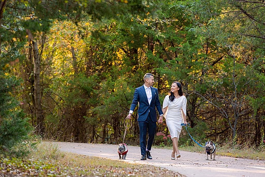 Couple walking 2 dogs during Engagement Photos at Arbor Hills Nature Preserve in Plano for engagement session