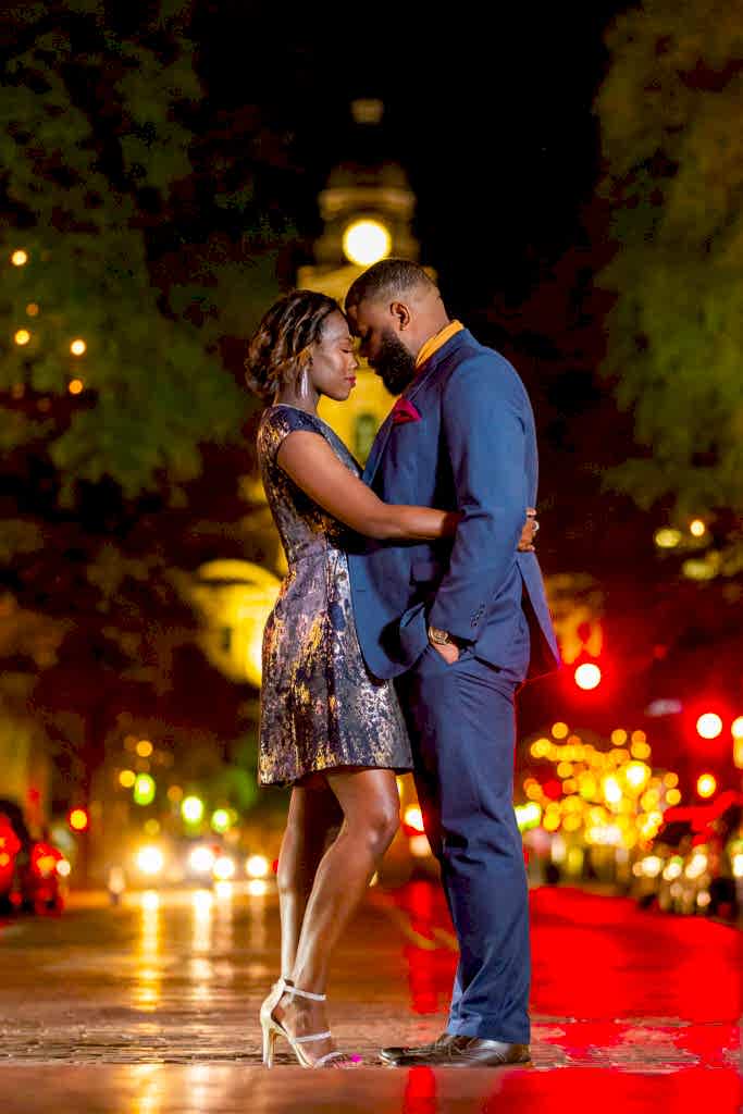 Intimate couple forehead to forehead during nighttime Fort Worth engagement session in Sundance Square Fort Worth Texas