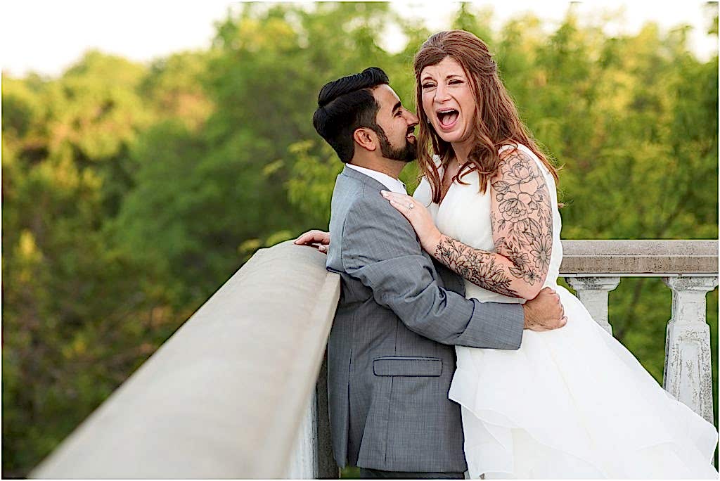 laughing bride with groom holding her outside their azle tx wedding venue