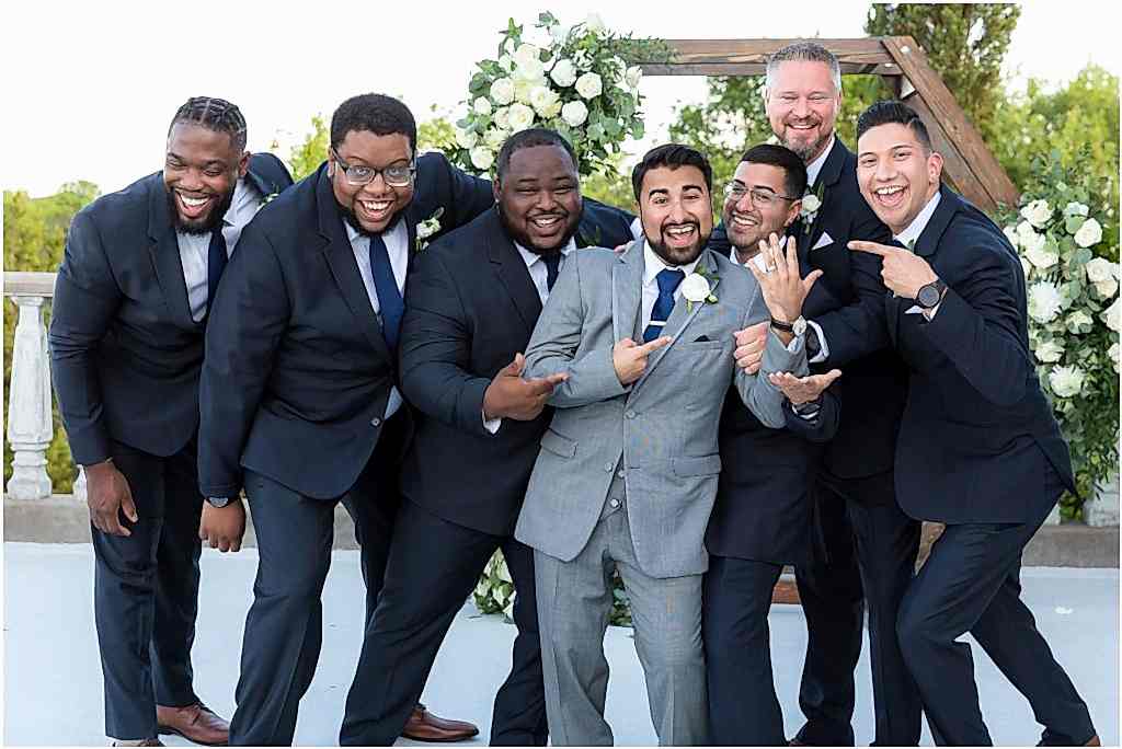 humorous groomsmen and groom photo showing wedding ring