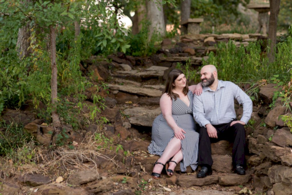 Dallas wedding photographer photographs engagement session at Texas Women's University with man and woman sitting together on a rock stair pathway