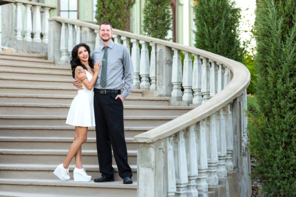 Engaged couple embracing on stone staircase