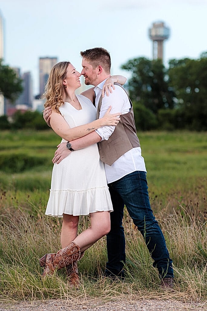 Dallas wedding photographer Stefani Ciotti Photography captures couple looking at one another in an embrace at Trinity Overlook Park