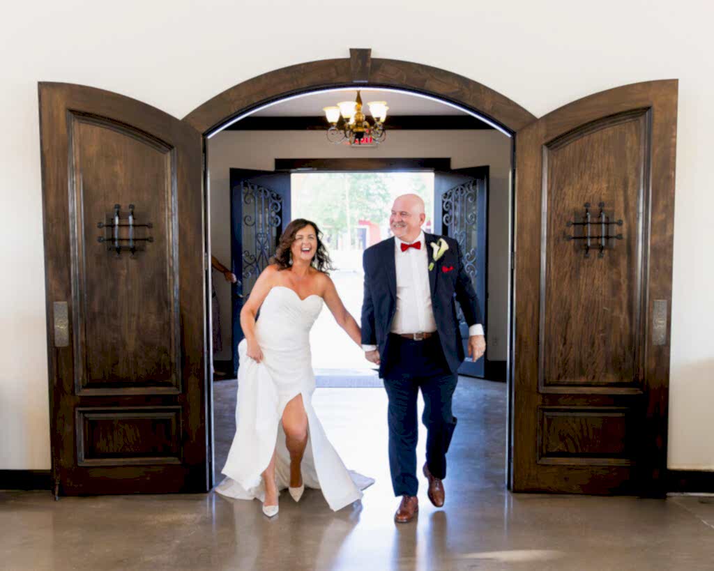 Bride and groom walking into reception Azle Tx wedding reception ballroom