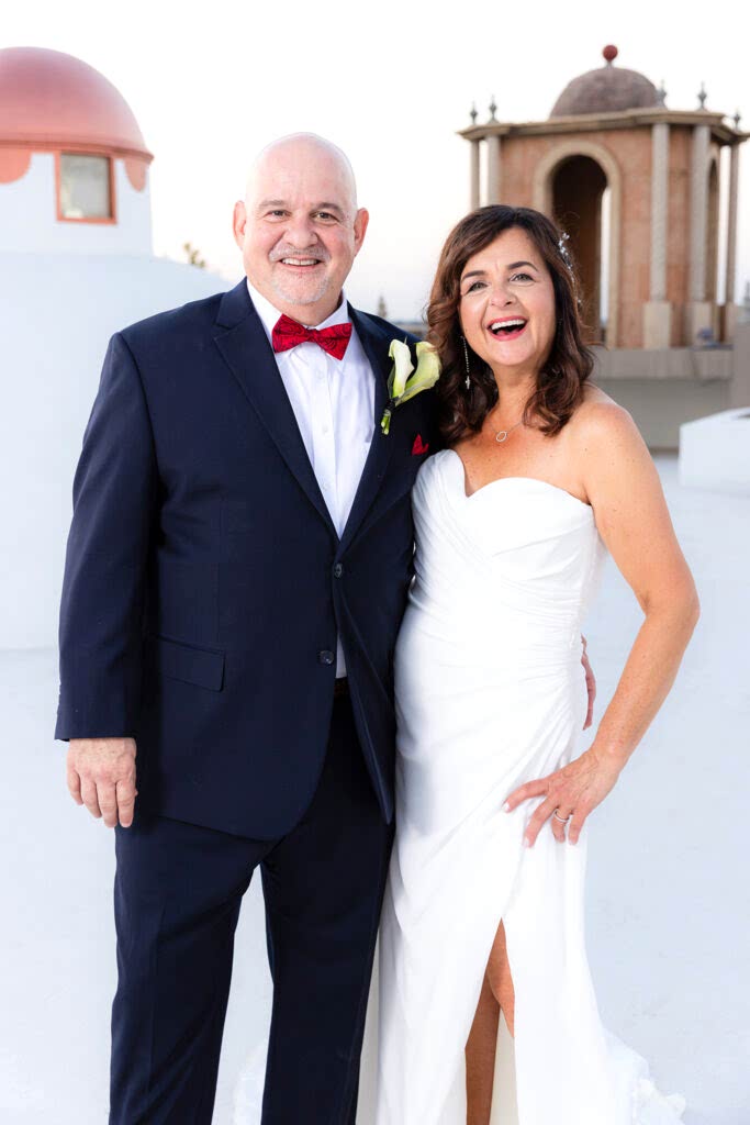 bride and groom smiling and laughing together on top of Stoney Ridge Villa's rooftop
