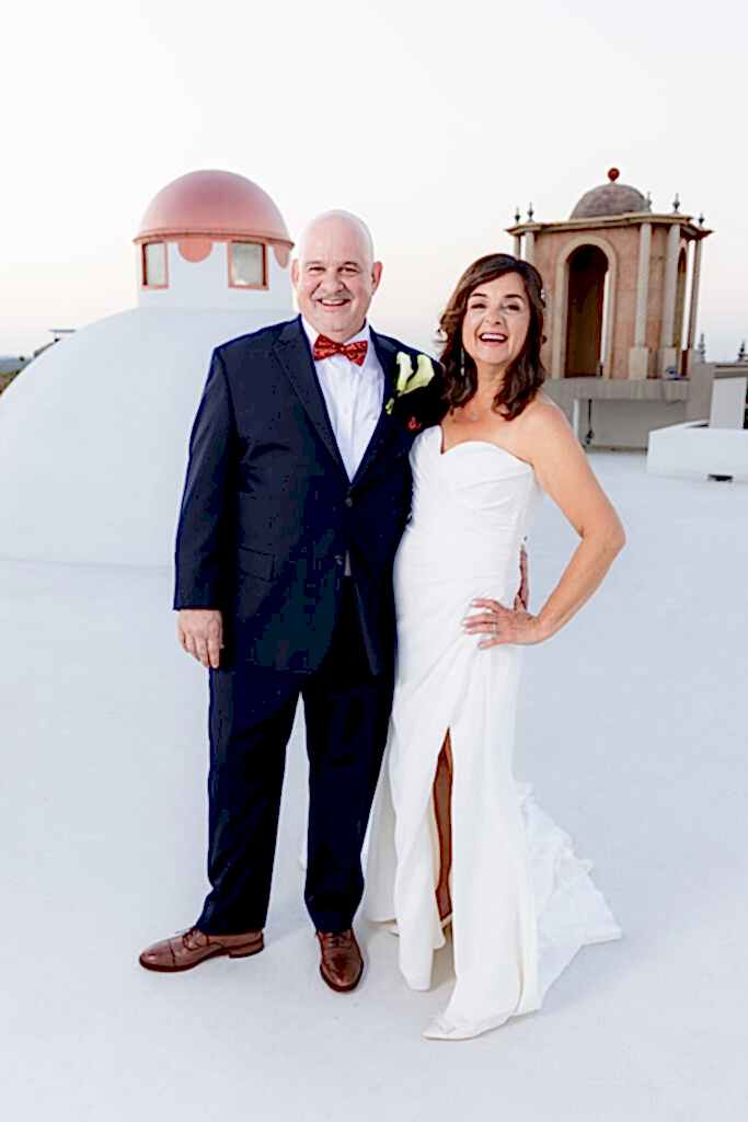 Bride and groom standing on venue rooftop together