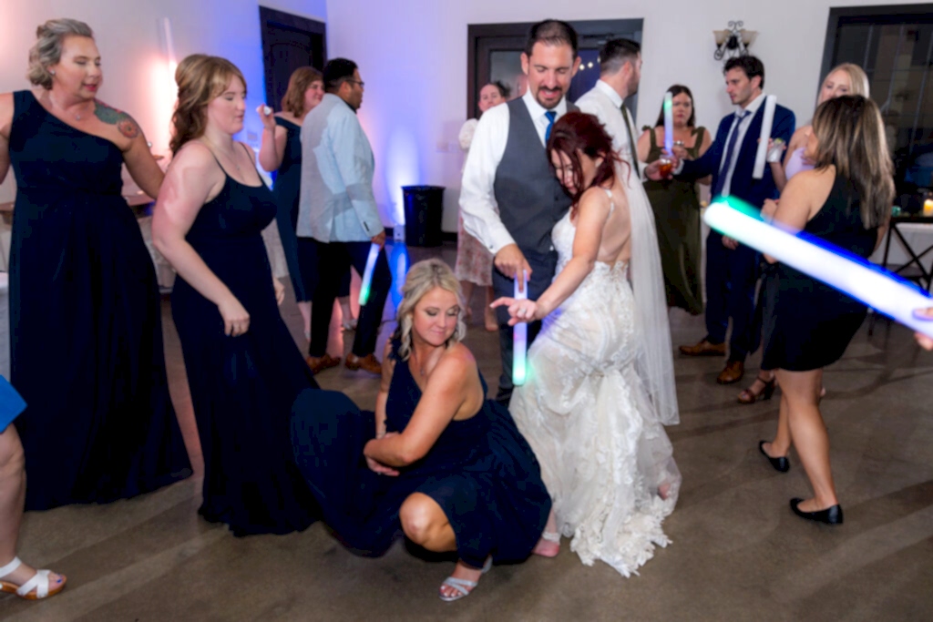 Bride dancing with bridesmaids and groom on dance floor