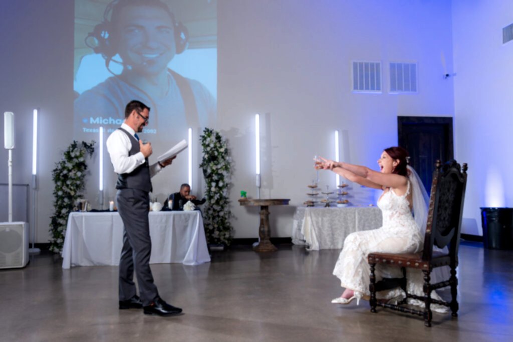Bride laughing at groom during speech at wedding reception
