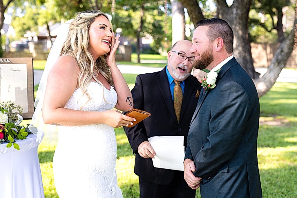 Bride and groom wiping tears from eyes and laughing during outdoor intimate elopement wedding ceremony
