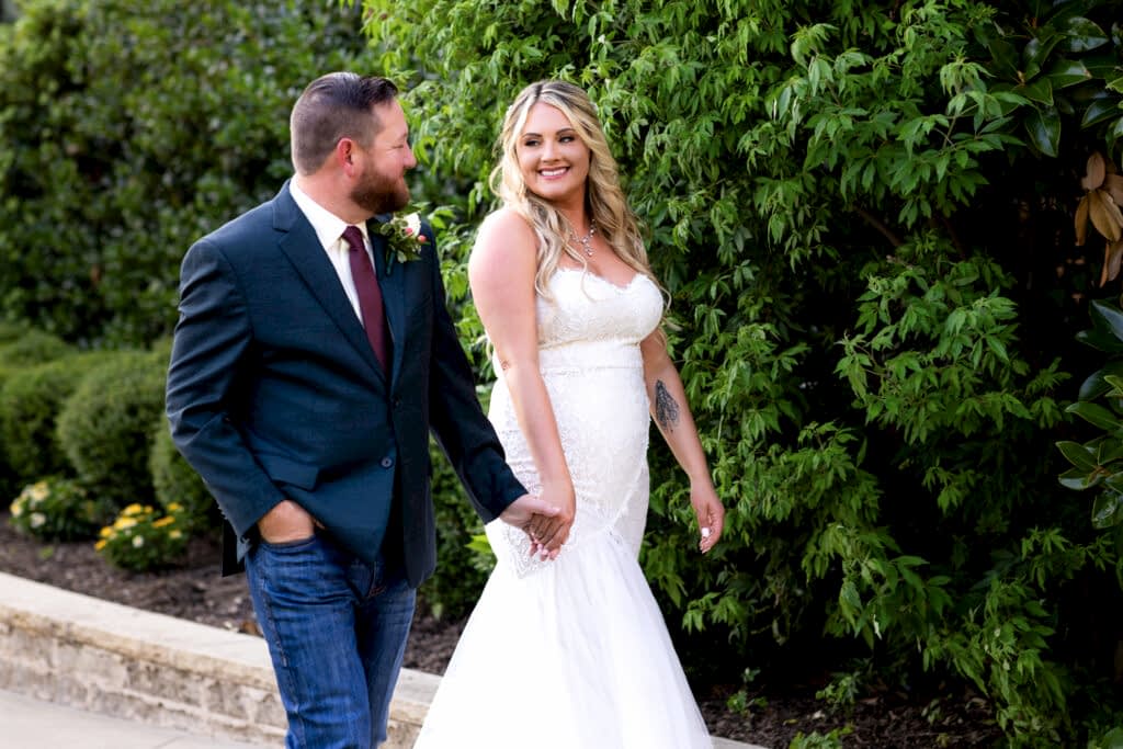 Wedding couple walking and smiling at each other