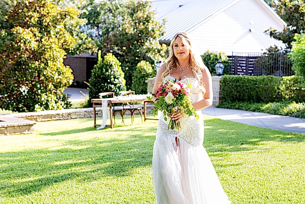 Bride walking across lawn before wedding ceremony