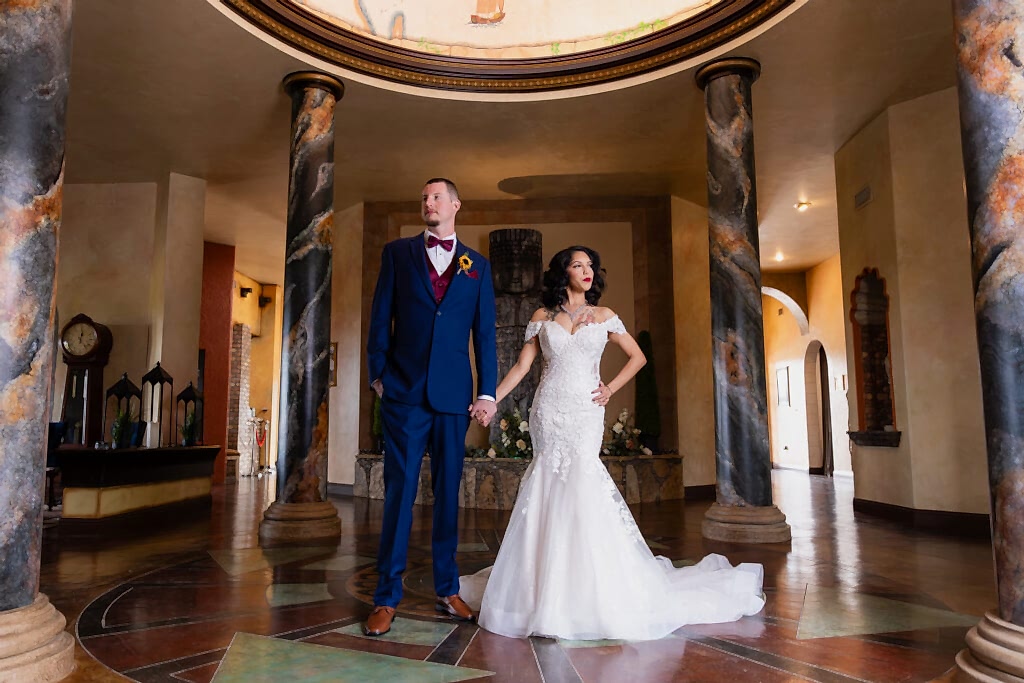 Bride and groom holding hands in gorgeous atrium at stoney ridge villa during Fort Worth Estate Wedding