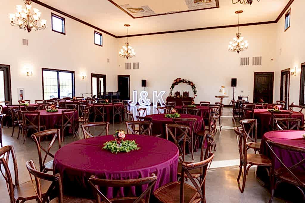 Reception banquet hall at Fort Worth Estate Wedding venue Stoney Ridge Villa with red tablecloths