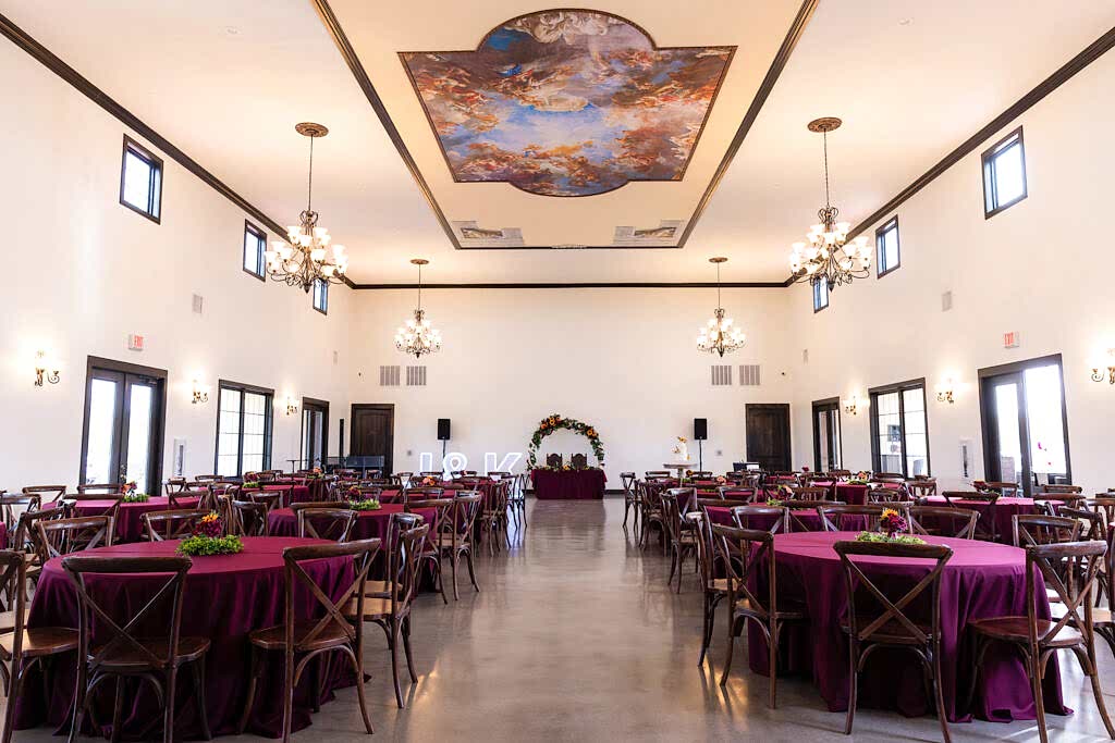 Fort Worth Estate Wedding venue Stoney Ridge Villa reception banquet hall with european style painted ceilings and red tablecloths