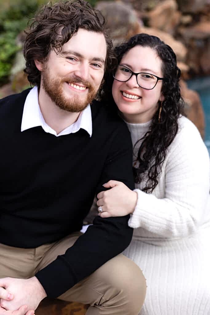 Cute engaged couple smiling at camera together