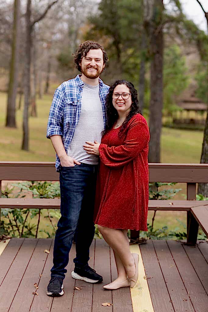 Engaged couple wearing red, white and blue during their lakehouse engagement session in Mabank