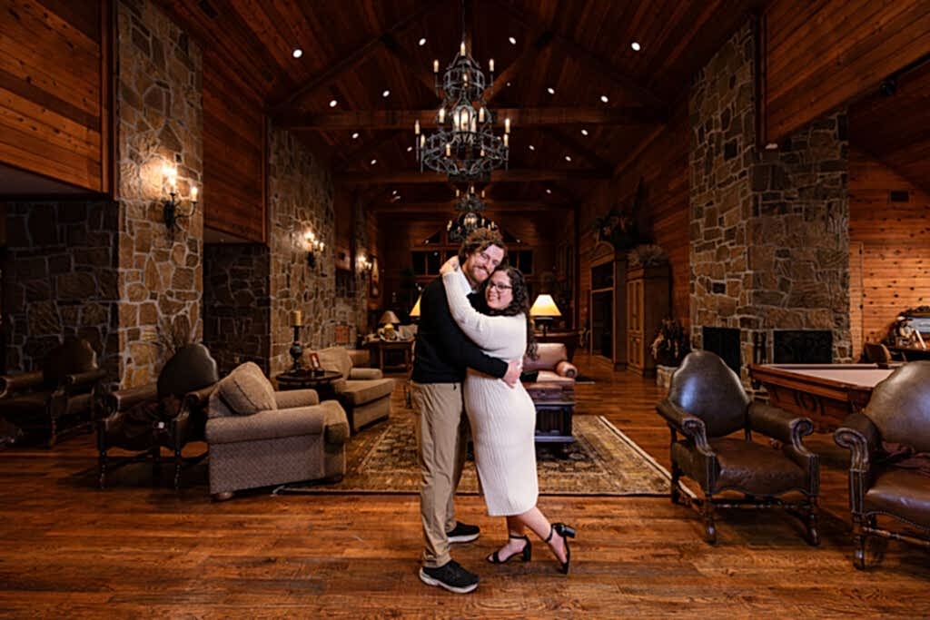 Engaged couple hugging with heads leaning towards eachother inside Mabank lake house during engagement session