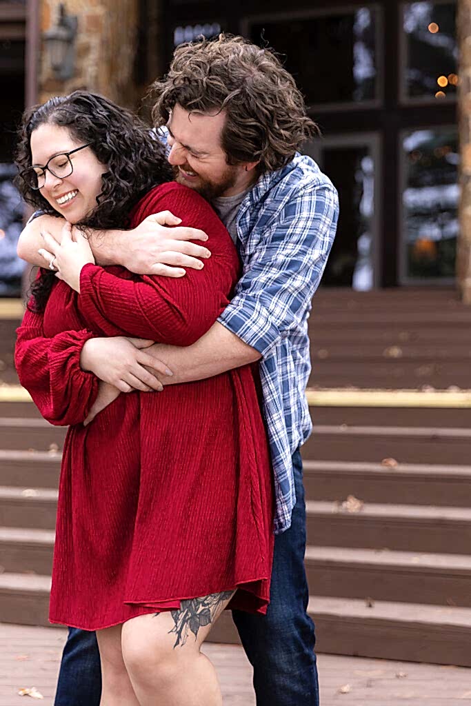 Engaged couple hugging and laughing