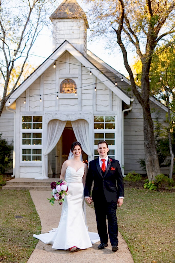 Bride and groom walking hand in hand away from Chandler Chapel at Bella Woods wedding venue in Midlothian TX surrounded by trees in the woods